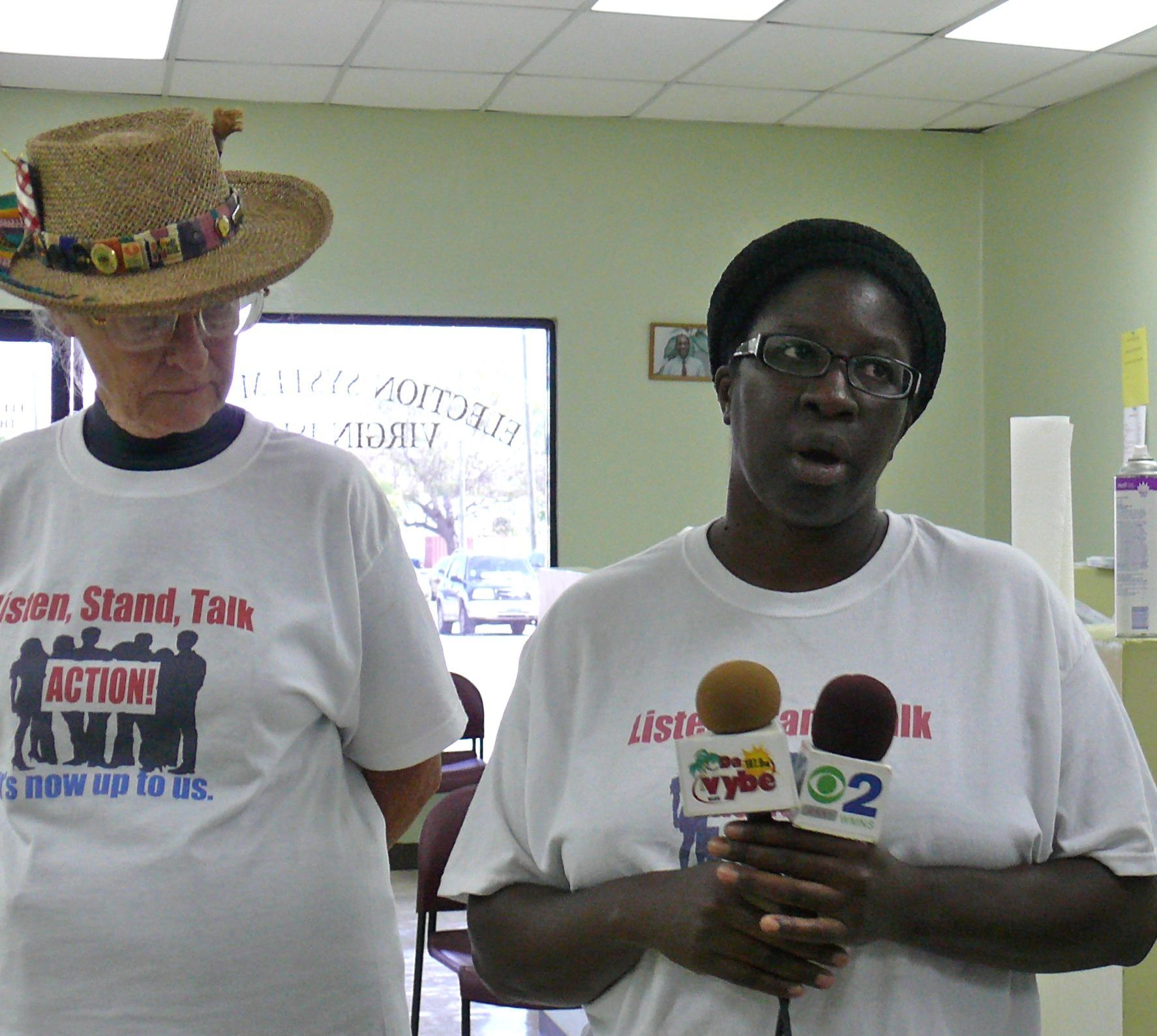 V.I. Action Group member Colleen Clarke talks to reporters with fellow activist Patricial Oliver.