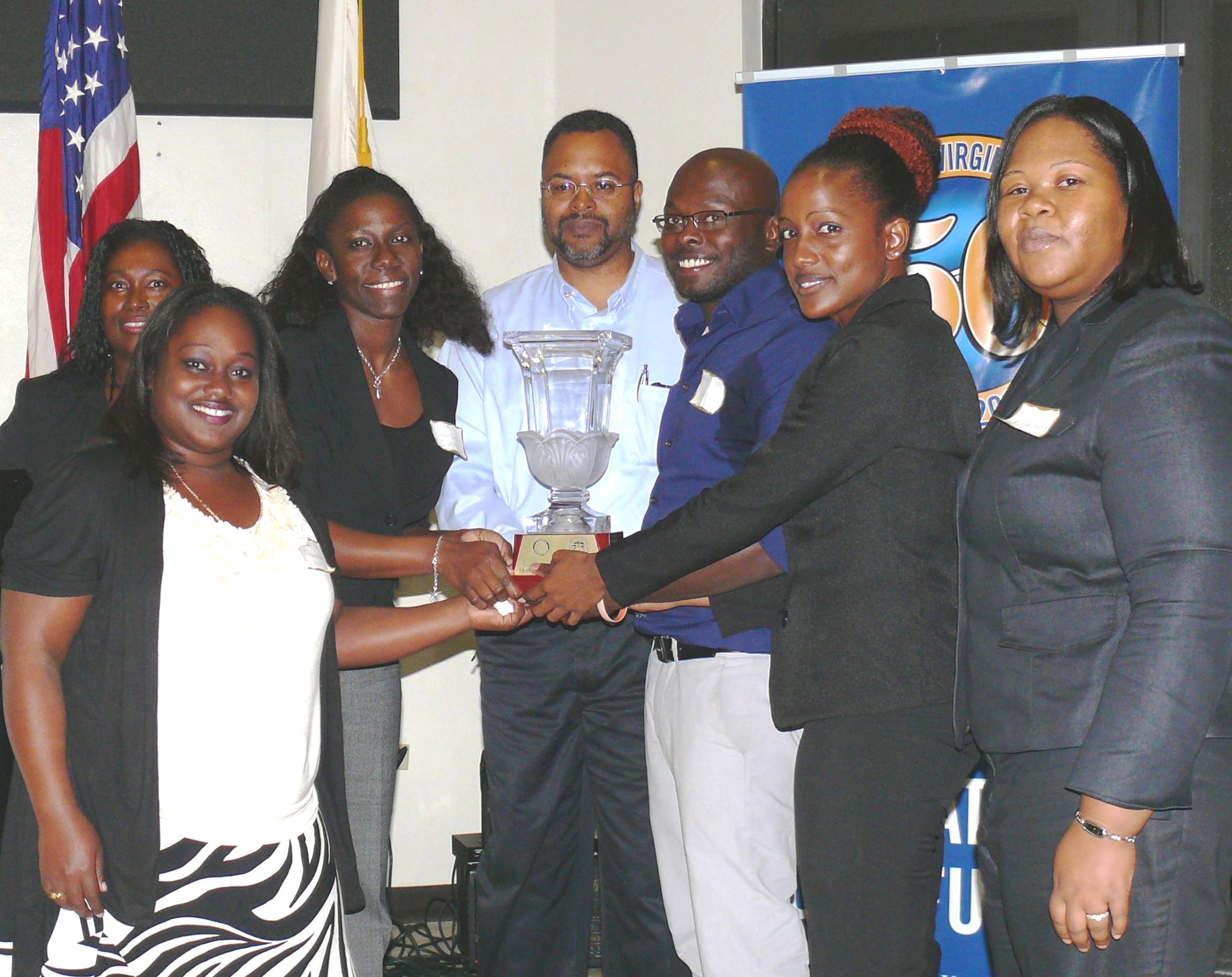 The St. Thomas team accepts this year's Model U.N. trophy.