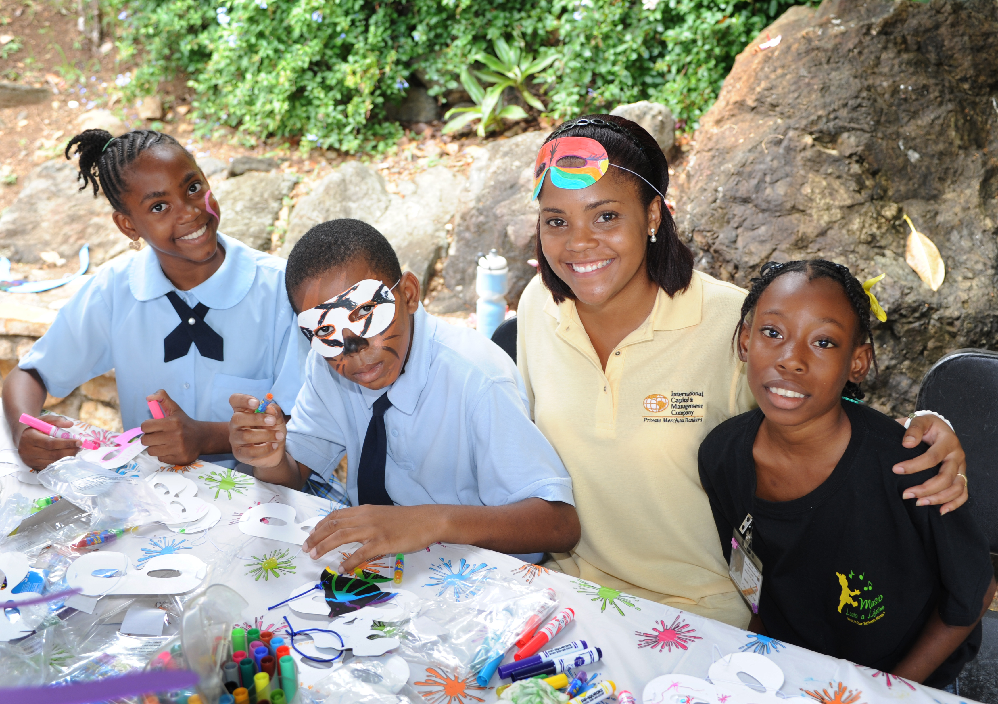 Children show-off their mask making creations (photo courtesy Chic Photography)..