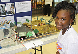 Khaila Pruiett shows off her project on hydroelectricity.