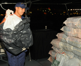 Coast Guardsman unloads part of a shipment of cocaine seized by the cutter Sapelo. (Photo courtesy U.S. Coast Guard)