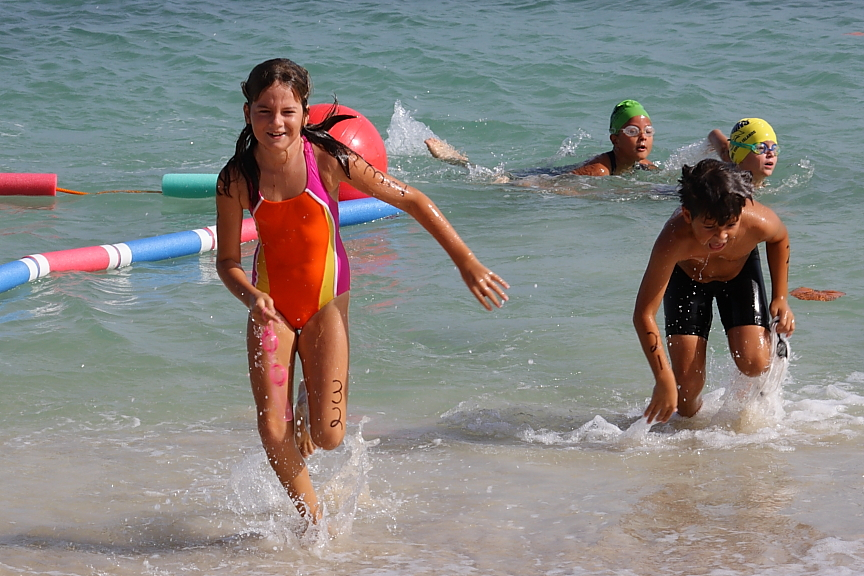 Aislin McStay is the first racer out of the water in the 7-8-year-old race.