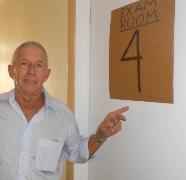 Michael Akin, executive director of Catholic Charities points out the exam room.