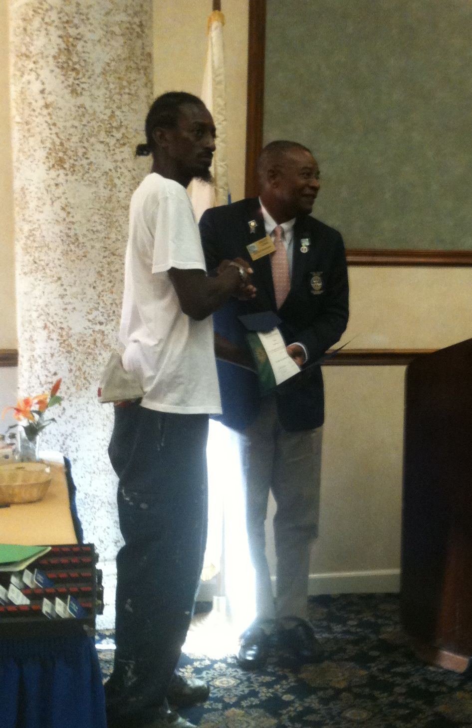 Edmund Armstrong, left, accepts Rotary International Charter from Rotary District Governor Vance Lewis.