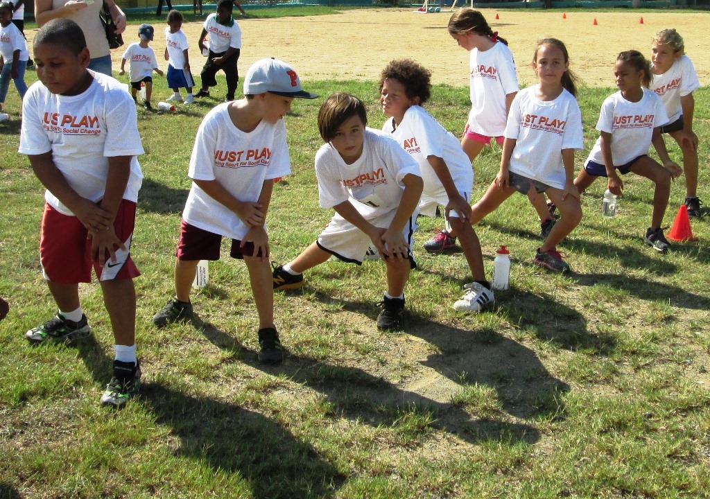 Just Play Day participants warm up at the Winston Wells ballfield.