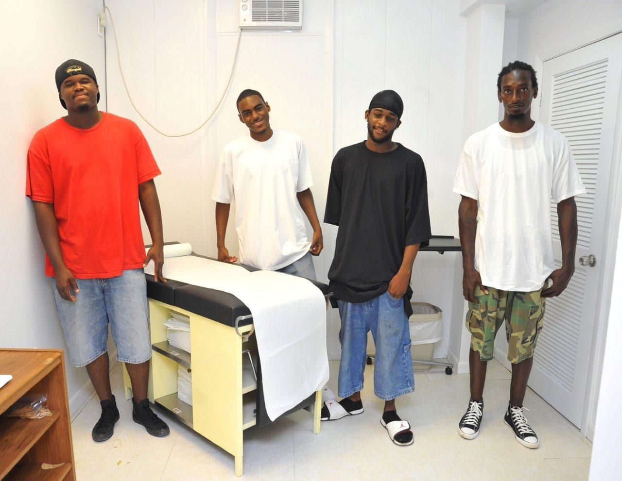 From left, Nathaniel Washington, Shaheem Miller, Orville Williams and Edmund Armstrong show pride in the examining room they built.