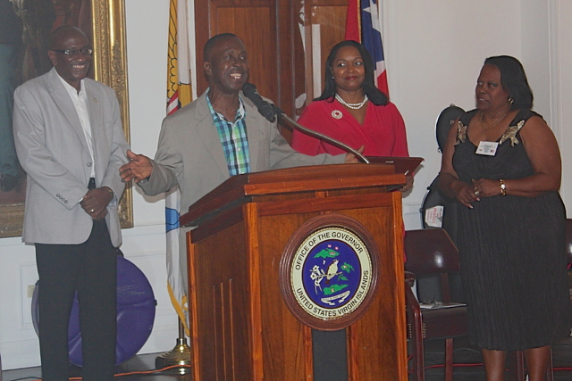 Camille 'King Derby' Macedon, at podium, accepts his award from the Virgin Islands Puerto Rico Friendship Committee Saturday.
