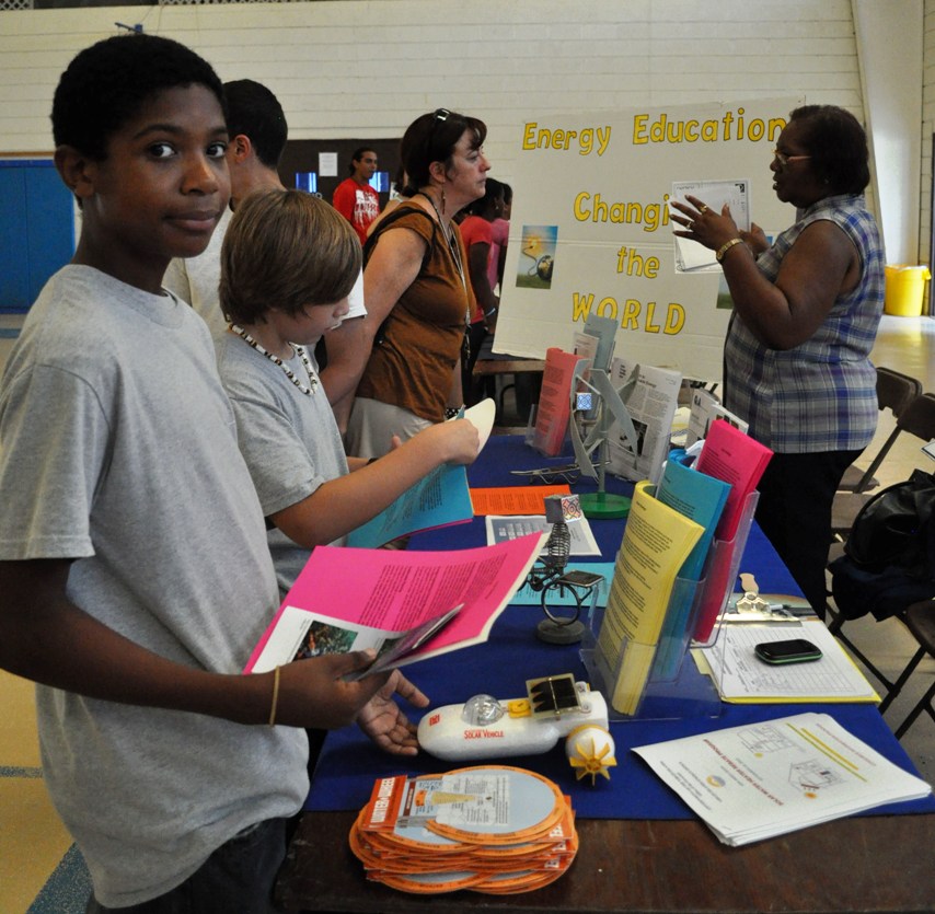  AZ Academy teacher Sarah Christiansen discusses energy careers with the V.I. Energy Office's Leila Muller as students Dionde Manon and Gavin Torres browse information material.