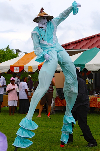 A moko jumbies entertains the crowd at the World Food Day celebration.