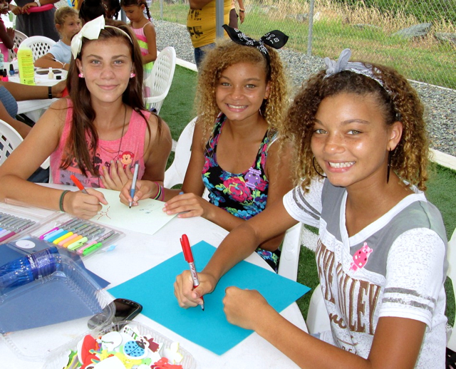 From left, Soleil Gessner, 12, Aysha Clendinen, 13, and Mirisa Clendinen, 13, take part in celebration of reading.