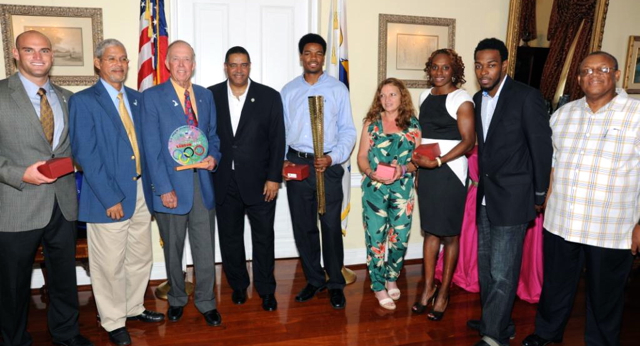 From left: Olympic swimmer Branden Whitehurst, Senate President Ronald Russell, VIOC President Hans Lawaetz, Gov. Jhn deJongh Jr., VI Olympic athletes: Muhammad Halim, Lee Frawley, Laverne Jones Ferrette and Tabarie Henry. Also pictured: Housing, Parks and Recreation Commissioner St. Claire N. Williams.