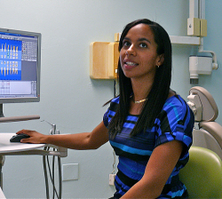 Dr. Talia Moses demonstrates the digital imaging and record-keeping technology at the new dental clinic.