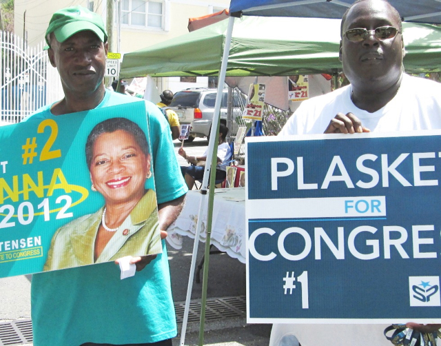 Alvis Christian, left, and Aubrey Bridgewater support opposing candidates outside their polling place on St. John.