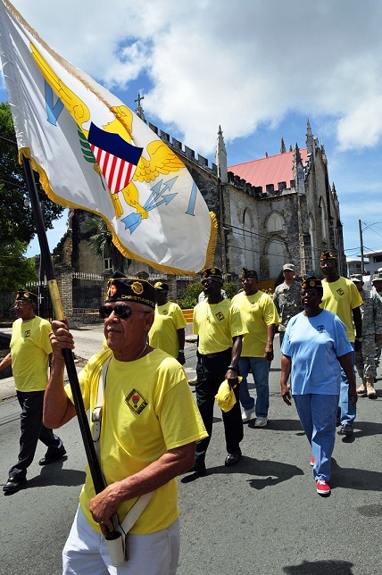Legionnaire and Vietnam War Veteran Antonio Martinez Jr. carries a flag while walking through downtown Christiansted in honor of 9/11 victims.