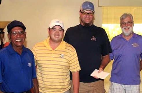 From left, the low-gross winning team of Wilfred Smith, Jonathan Chen and Russ Seigler (Missing: Dutch Waters.) At right, Rotary Sunrise President Fred Warden.