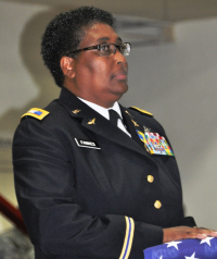 Col. Caroline F. Fawkes holds her retirement flag.