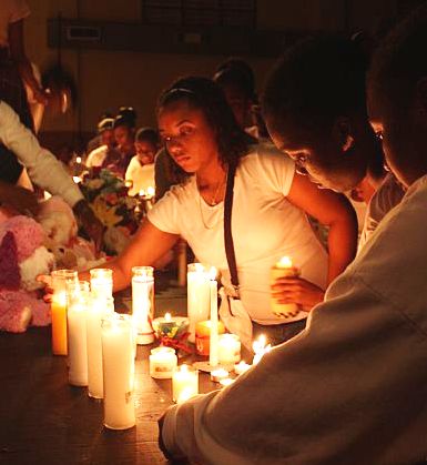 Kean High School students light candles at Monday night's vigil.
