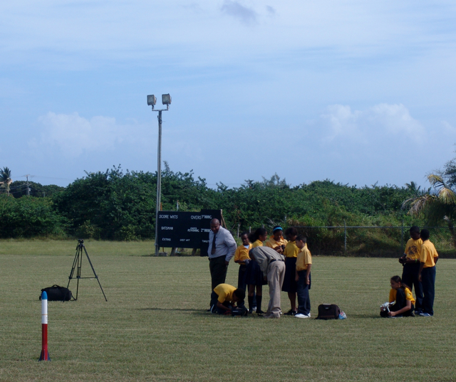 Members of the rocketry club check their connections while the rcket sits, waiting to launch.