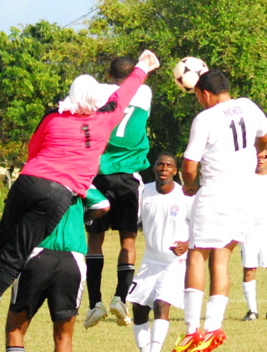 Skills goalie Darryl Gussie punches the ball off the head of Freewill striker Jose Nieves.