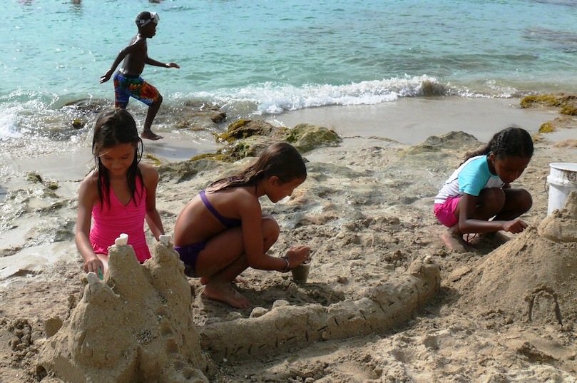 Solvana and Kendra Butler of Cane Bay build sandcastles with their friend Rorie Johnson (Bill Kossler photo).