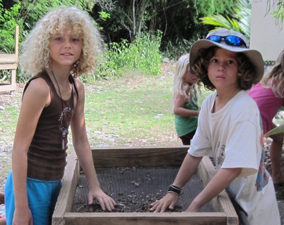Caitlyn Born, 9, and Adrian Turbe, 8, both of St. Thomas, work on a gardening project.