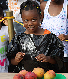 Faith Boirard prepares to devour a bunch of mangoes.