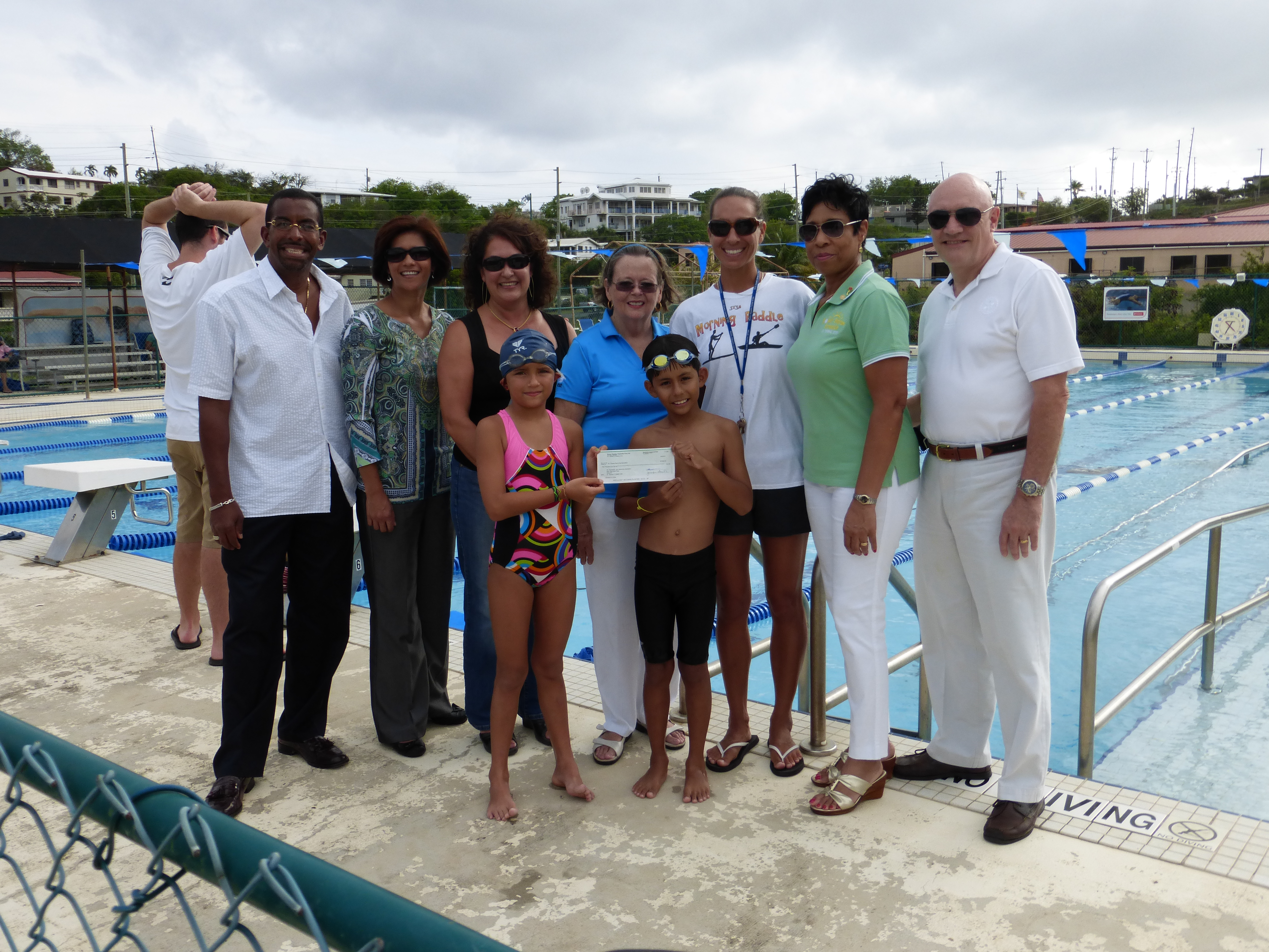 Standing in front (left to right) are STSA Stingrays and triathletes Audrey Moore and Diego Villegas.  In back are STSA board members Frank Odlum and Madel Villegas (a triathlon volunteer);  Rotary Sunrise members Susan MacFarland-Helton and Diana Parker; STSA Liz Estes (the triathlon swim coordinator); Pat and Nigel Bailey of Rotary Sunrise.