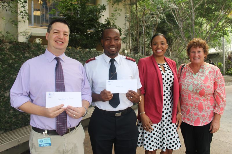 from left, Rabbi Michael Harvey, Capt. Kevin Bryan, Shanique Woods-Boschulte and MaryAnn Brown - representing the Hebrew Congregation of St. Thomas, Salvation Army of the Virgin Islands and Charlotte Kimelman Cancer Center stepped on stage Friday to accept Day of Giving donations from the students