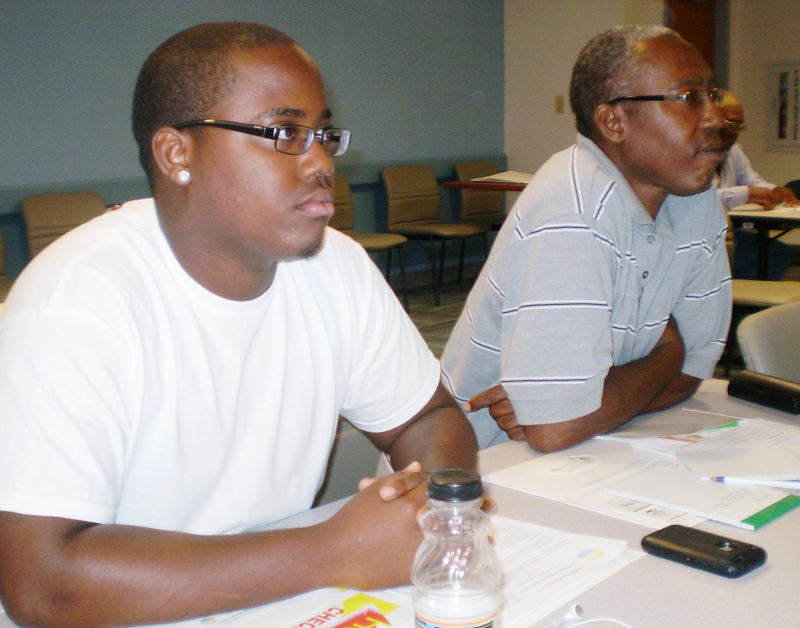 Builders Jesse and Derek Atwell listen attentively to Klein's "green" message.