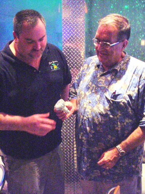 Beni Iguana's sushi restaurant owner/manager Todd Reidhard (left) takes a look at Bob Witwer's LED energy-thrifty bulbs from Southern Lighting Company.