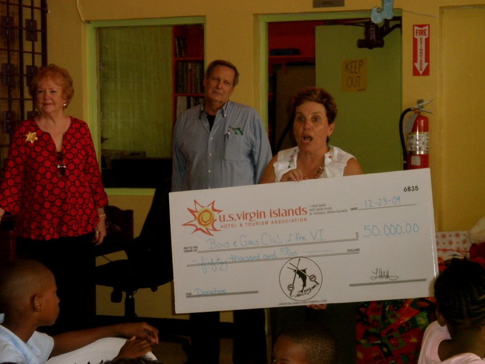 Boys & Girls Club Executive Director Julie Landreau elicits cheers from the crowd as she displays the oversized check Wednesday. 