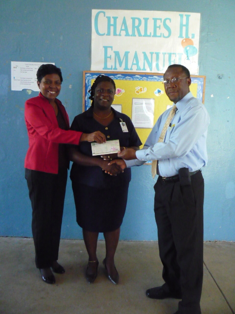 First Express Branch Manager Deborah Boone and General Manager Alphonso Meade present a check to the Charles H. Emanuel NASA Explorer School Assistant Principal Delicia Espinosa (center).