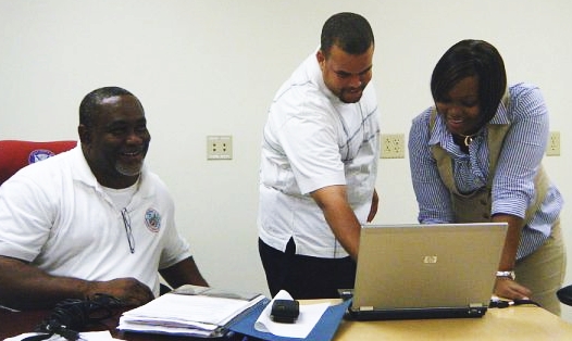 From left: Avon Chesterfield, VITEMA Communications Officer Joseph Hodge and the district's 911 manager, Carolyn Wattley, talk about the ongoing training.