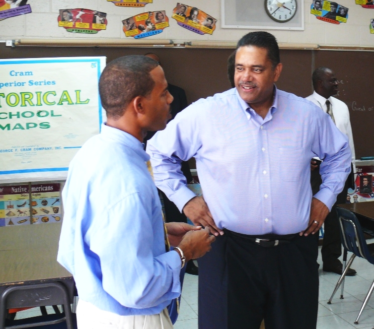Rameek Croskey, a U.S. History teacher at Woodson, speaks with Gov. John deJongh Jr. during Monday's school tour