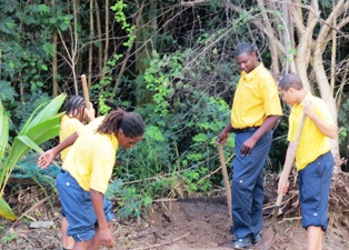 Students look for fertile soil to plant cold crops during an ECJH Agriculture Class session.