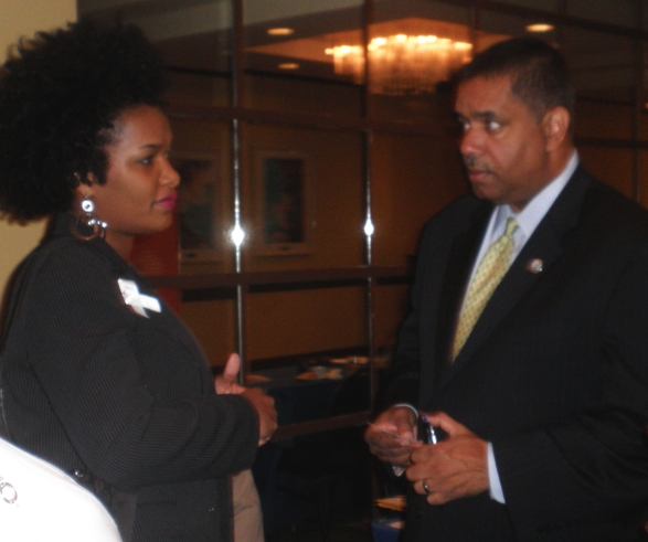 Rudelle Handy, program manager of the U.S. Dept. of Justice's Office On Violence Against Women, speaks with Gov. John deJongh Jr.