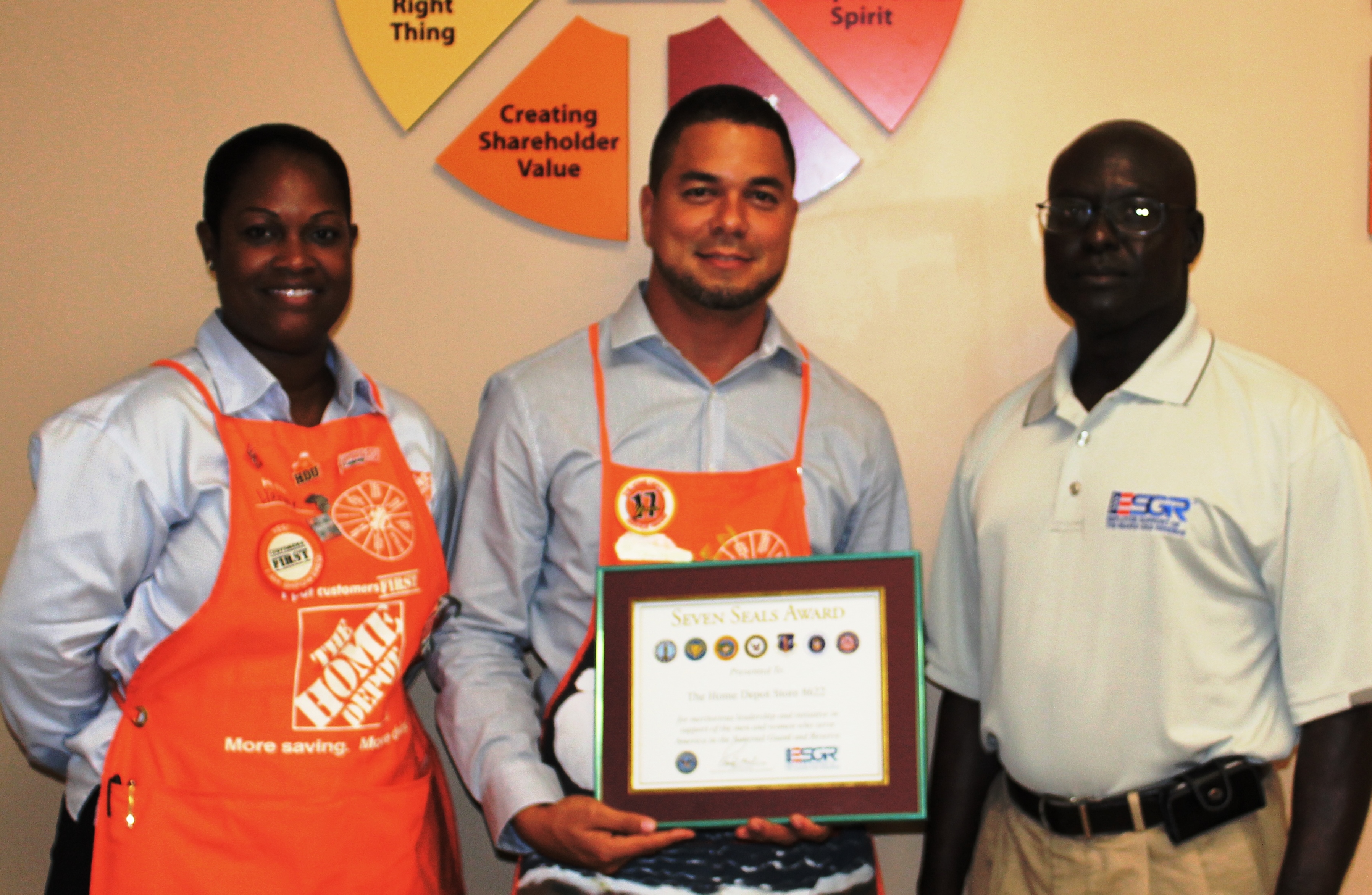 V.I. State Chair Beresford Edwards (right) presents Home Depot representatives, Hermeian Leon, human resources manager and Warren Cork, store manager, with a Seven Seals Award.