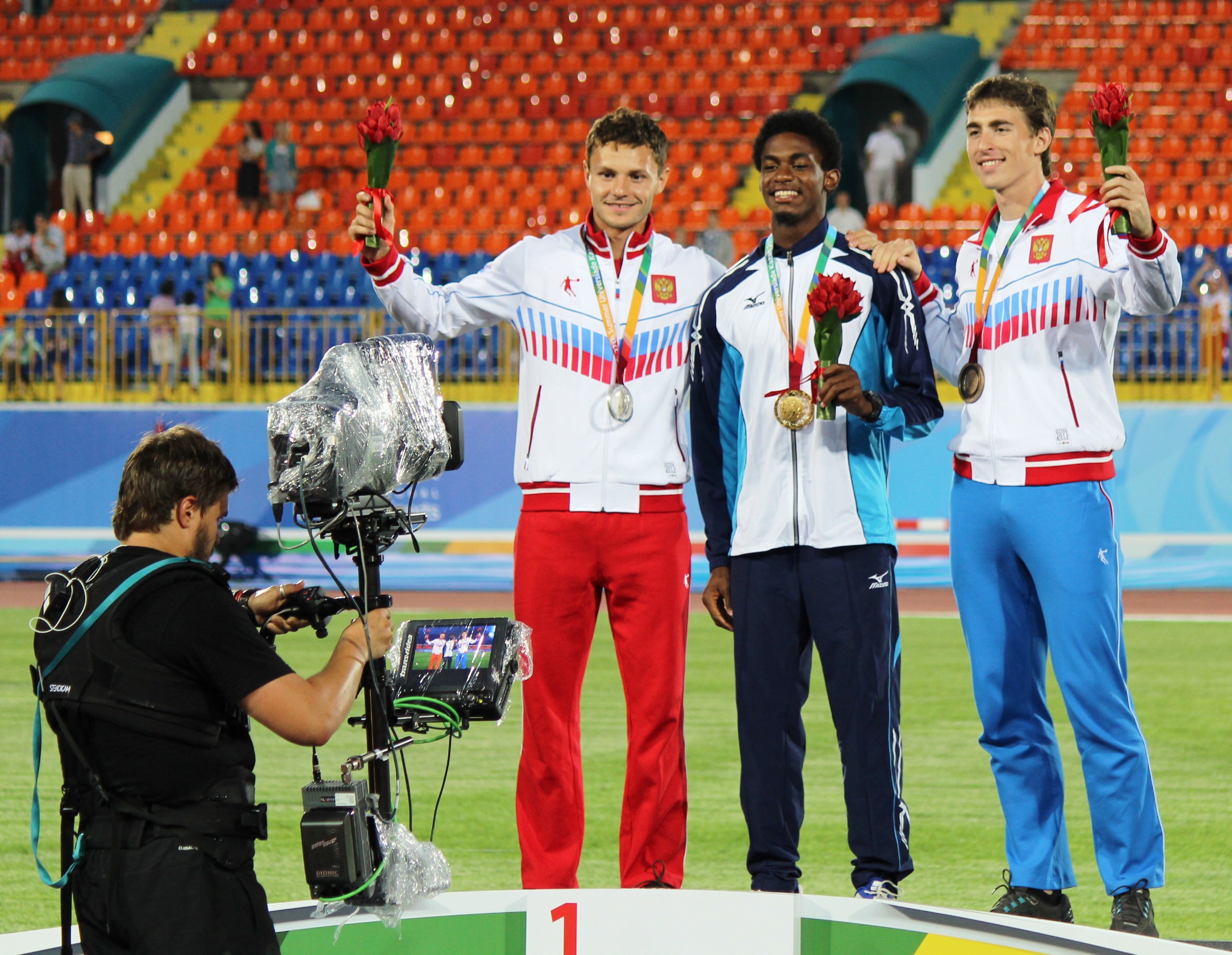 Eddie Lovett (center) wins gold at World University Games
