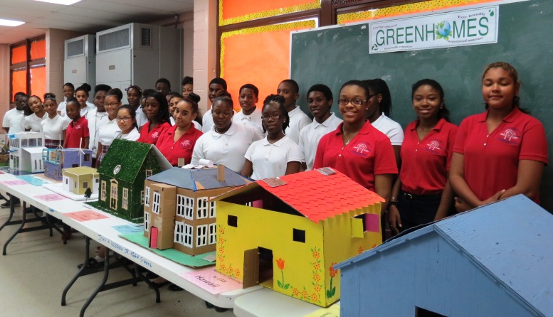 Students stand behind their green homes at the John H. Woodson Junior High School Science Laboratory. 