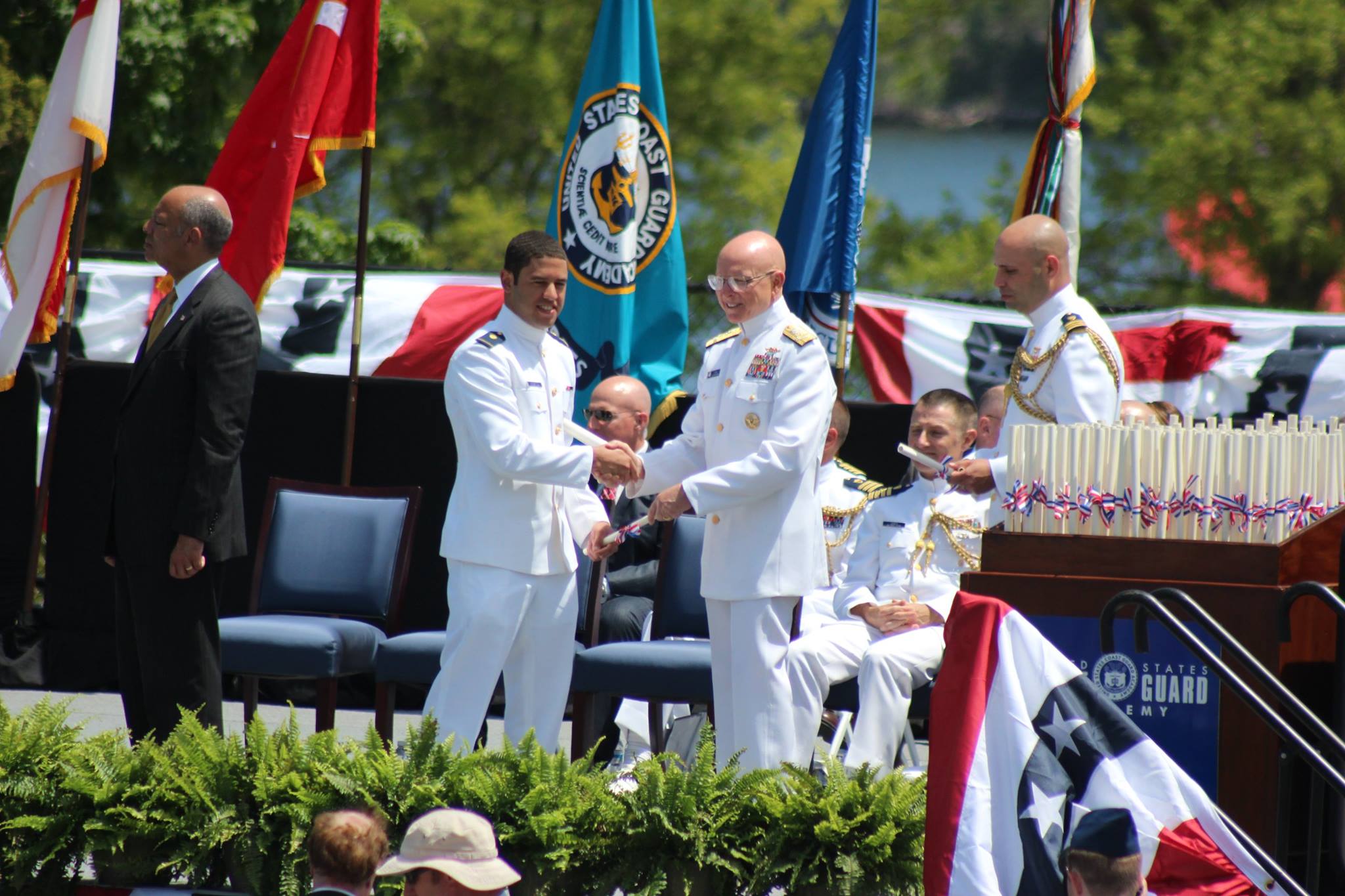  Ensign Jamen Descartes receives congratulations from DHS Secretary Jeh Johnson and U.S. Coast Guard Commandant Admiral Robert J. Papp 