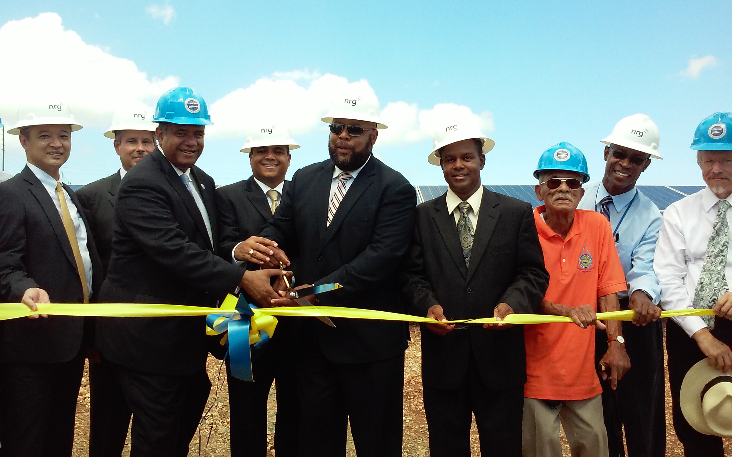 Gov. John deJongh Jr. and WAPA Executie Director Hugo Hodge Jr. and others cut ribbon on solar facility in Spanish Town Monday