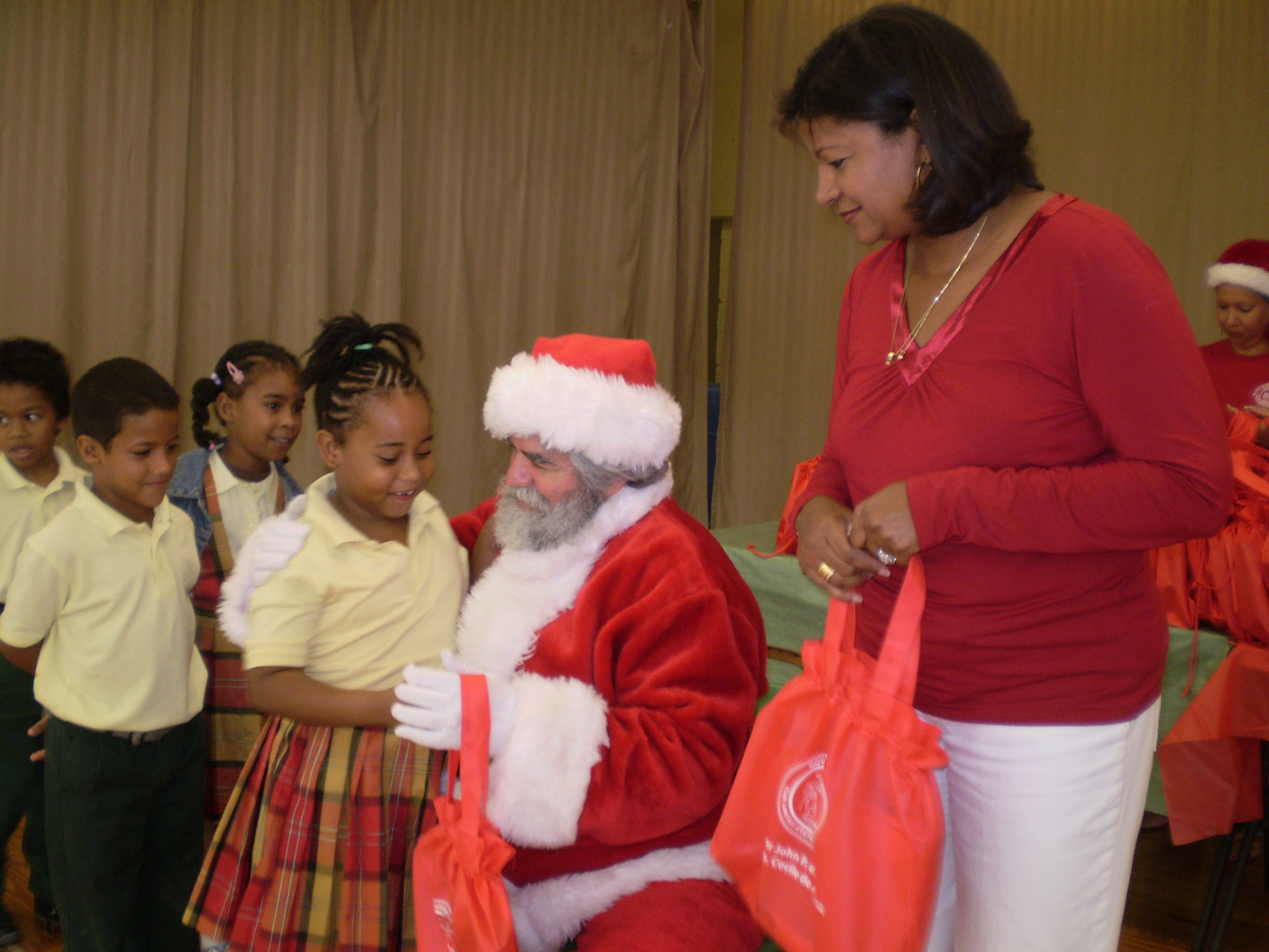 Melissa Ferreras, Santa (aka Chris Finch, Department of Human Services commissioner), and first lady Cecile deJongh.