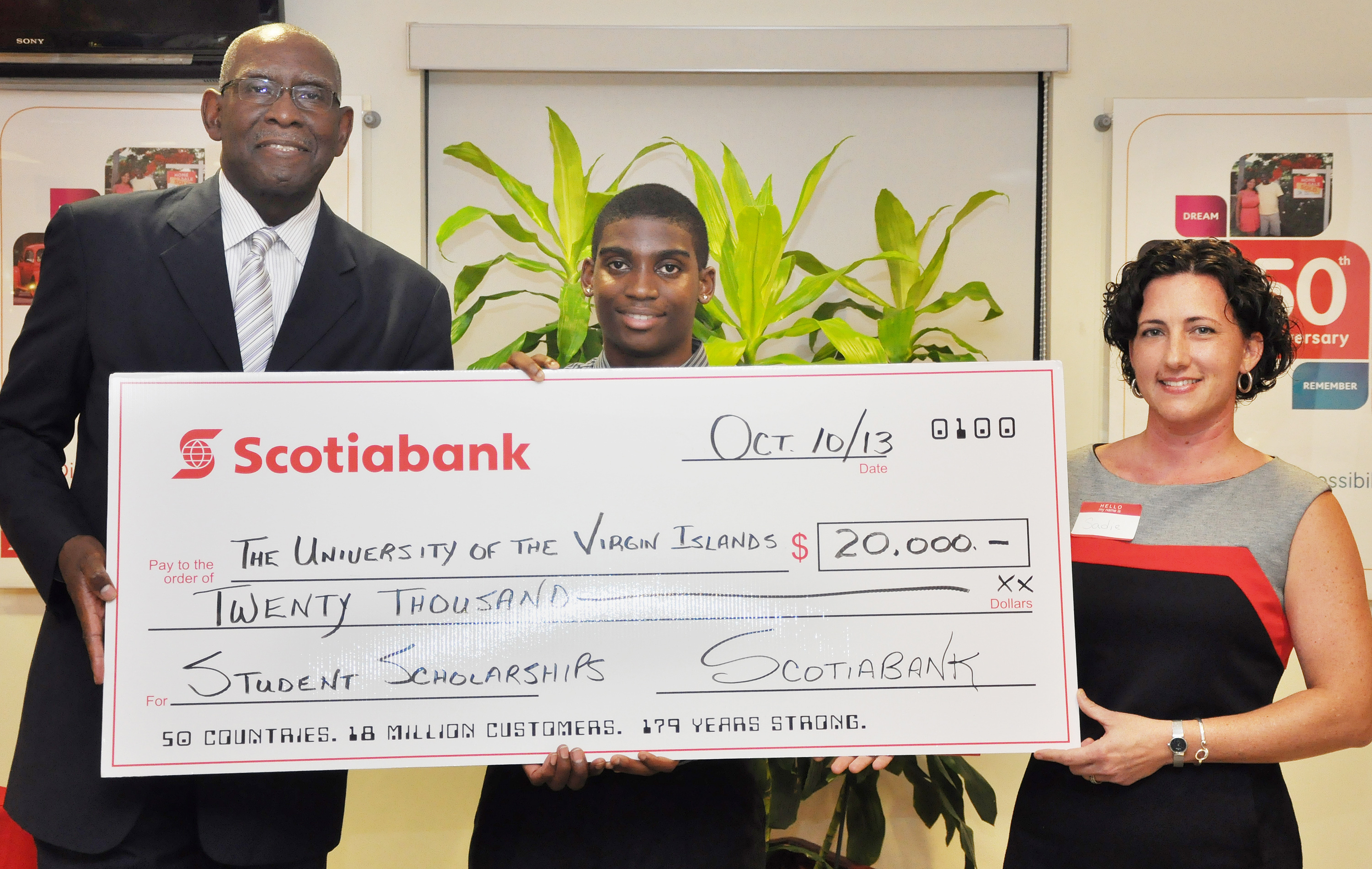 On hand for Scotiabank’s presentation of a check for $20,000 to the UVI Scholarship Fund were, from left, UVI President Dr. David Hall, student scholarship recipient Devon Williams and Scotiabank Marketing Manager Sadie Taylor-Clendinen. 
