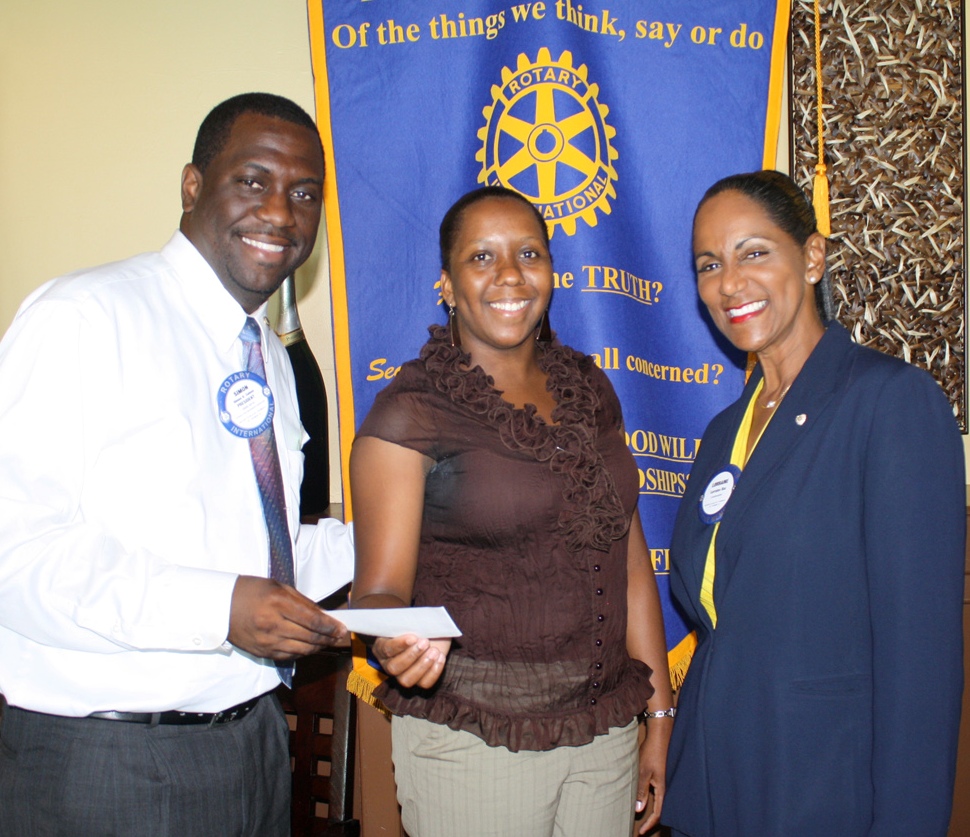 Rotary II President Simon Caines and Chairperson Lorraine Baa present an award to the 2010 Teacher of the Year Natasha Penn. 