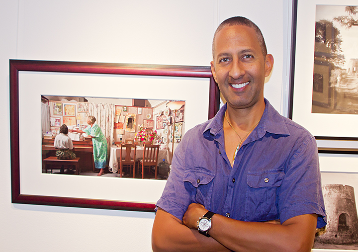 Ted Davis stands next to his photograph