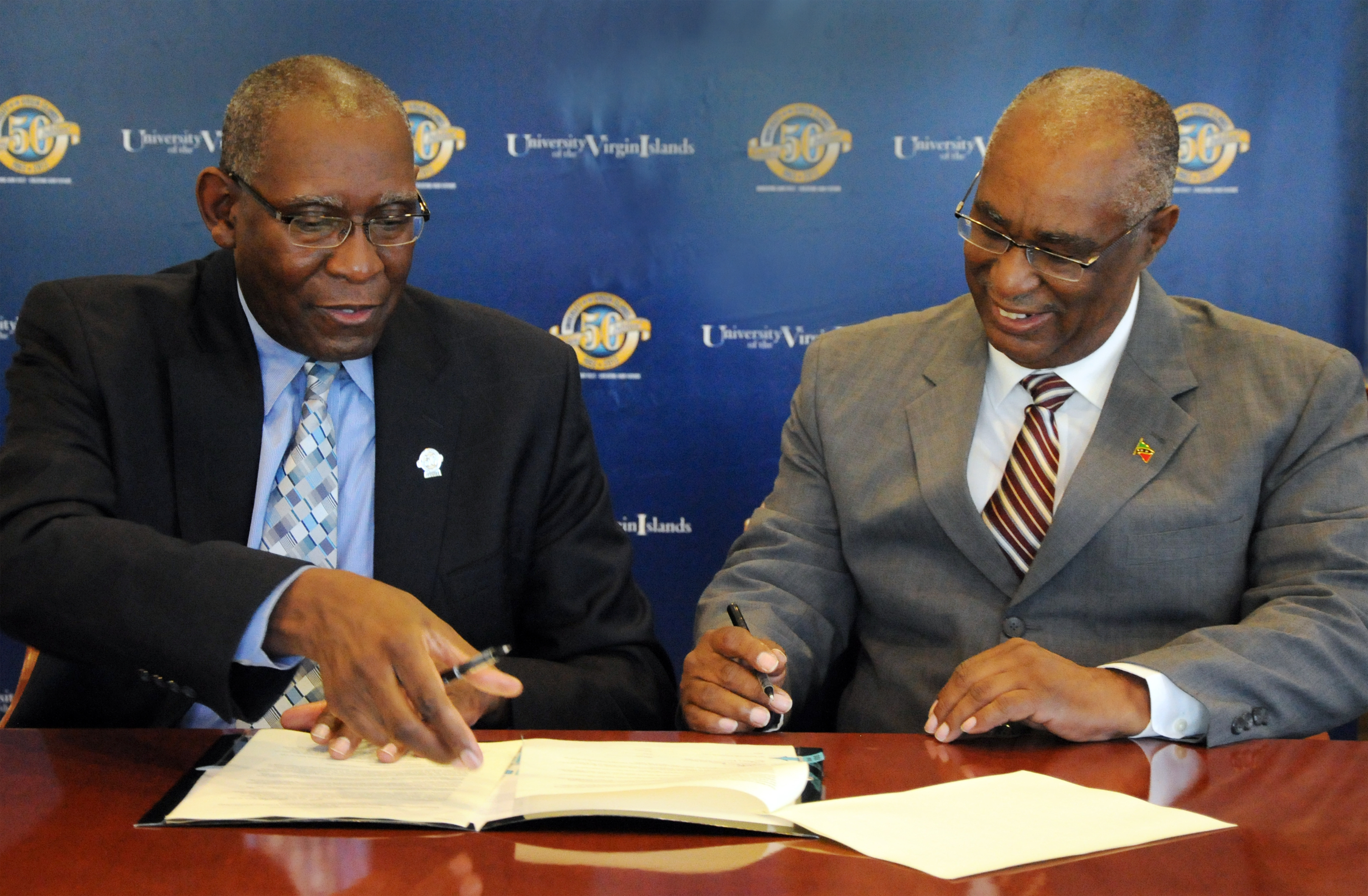 UVI President Dr. David Hall, left, and the Honorable Joseph Parry, Premiere of Nevis, sign an agreement that will allow graduates from the Nevis Sixth Form College to attend UVI at a tuition rate of only 1.75 times the rate for Virgin Islands residents. The agreement, signed at UVI on Nov. 2, also commits the Nevis Island Administration to provide scholarships for students from Nevis to attend UVI. 