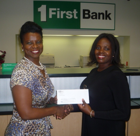Maria Connor Freeman (left) FirstBank vice president, Commercial Lending Department, presents a check to Cherise Creque, executive director of the United Way St. Thomas/St. John Chapter.  