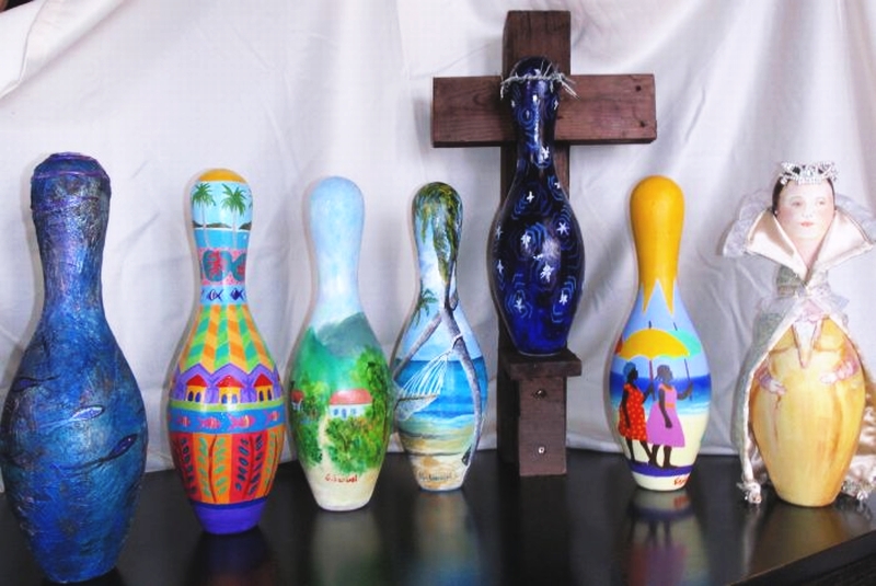 These bowling pins, decorated by top local artists, will be up for auction Friday night.