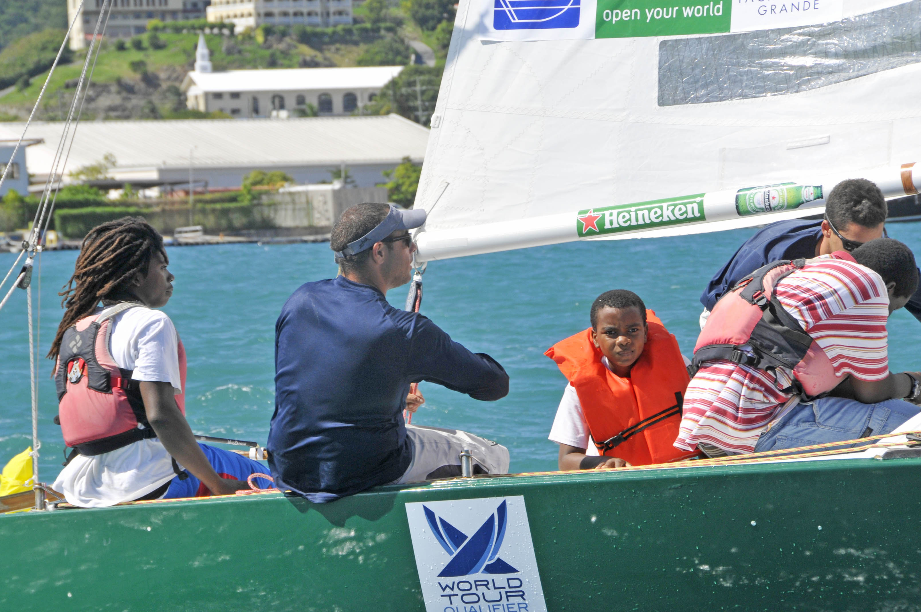 Lukata Samuel (left) tests the helm while Greece’s Stratis Andreadis (right of Samuel) calls tactics in the Carlos Aguilar Match Race Youth Regatta, sponsored by Budget Marine. (Credit: Dean Barnes)