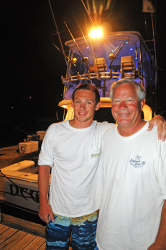  L to R: Mason Domel and father Gary Domel, in front of their 48-foot Cabo, Deguello. Seventeen-year-old Mason released a nearly 600-pound blue marlin after a nearly 2 hour fight. Credit: Dean Barnes